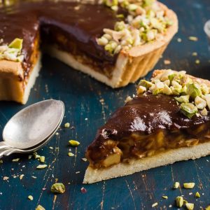 Tart with caramel, chocolate and nuts